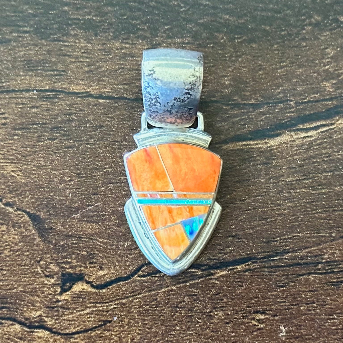 A Signed Orange Spiny Oyster Opal Sterling Triangular Inlay Pendant